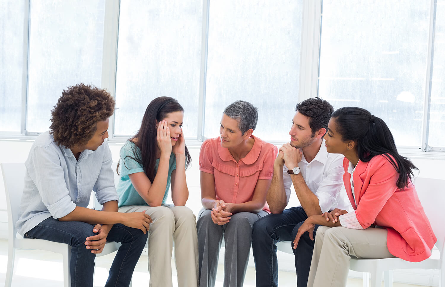 Group therapy session listening to woman tell story
