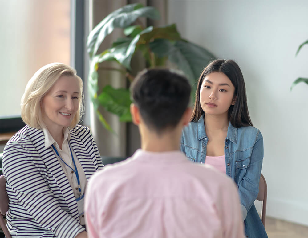 Three people sitting at therapy